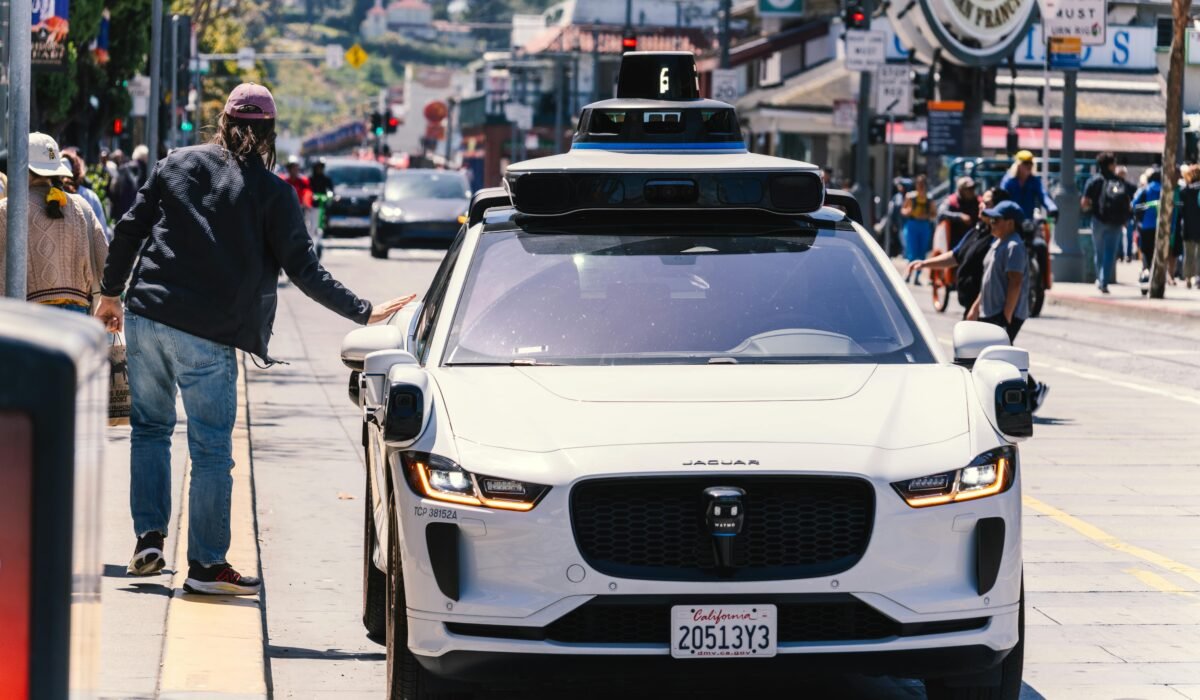 A self-driving car navigates through a bustling city street in San Francisco, capturing urban mobility in action. — Photo by Abhishek Navlakha on Pexels