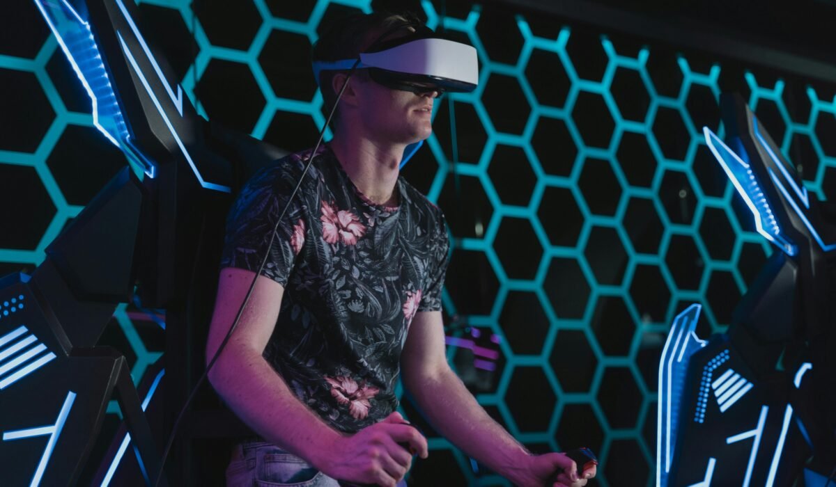 An adult male enjoying a virtual reality game in an arcade setting with futuristic elements. — Photo by Tima Miroshnichenko on Pexels