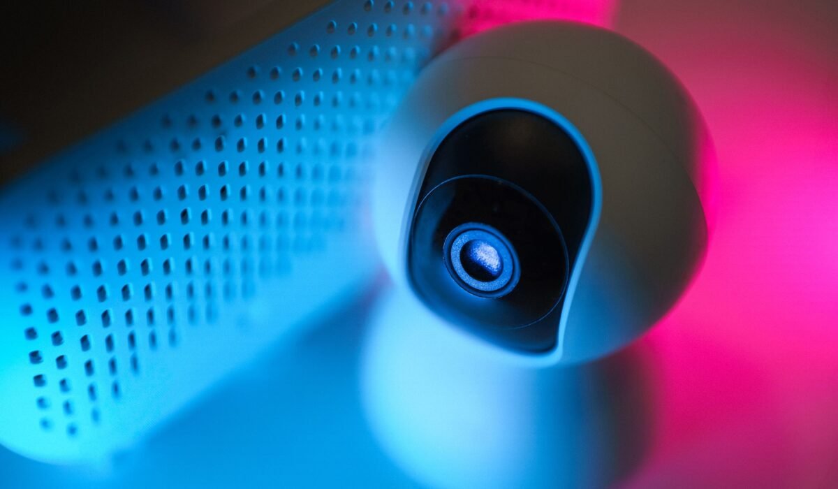 Close-up of a surveillance camera with neon lighting, symbolizing modern home security technology. — Photo by Jakub Zerdzicki on Pexels
