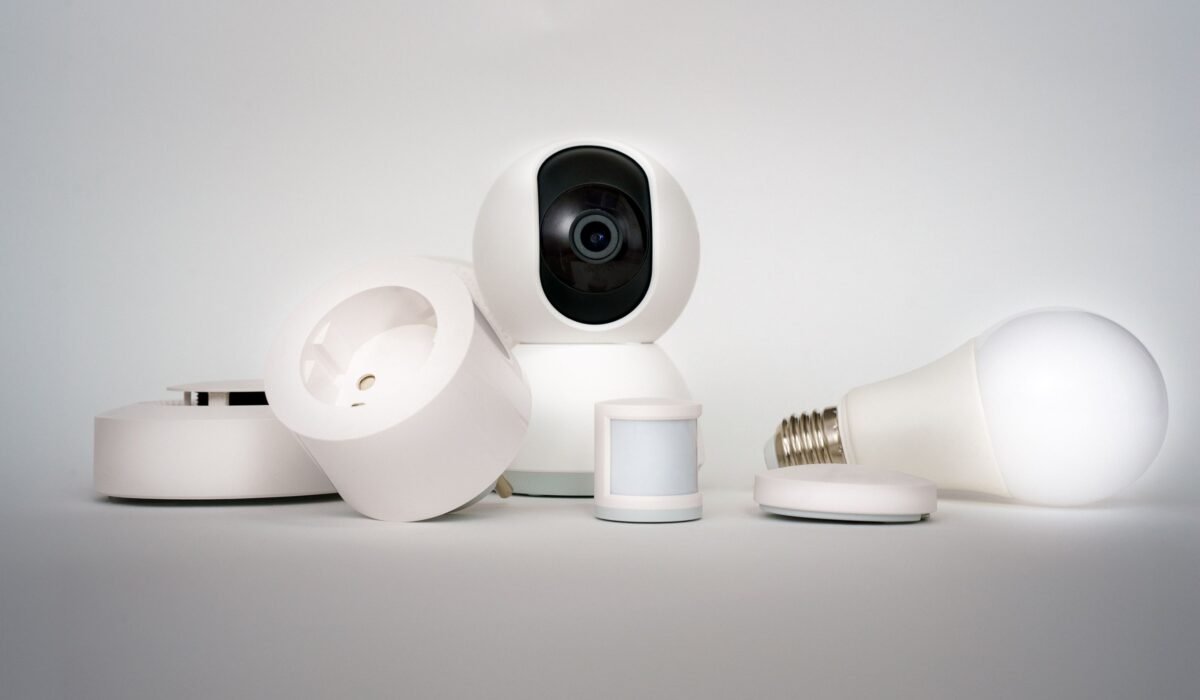 A range of smart home devices including camera and lightbulb in a minimalist setup. — Photo by Jakub Zerdzicki on Pexels
