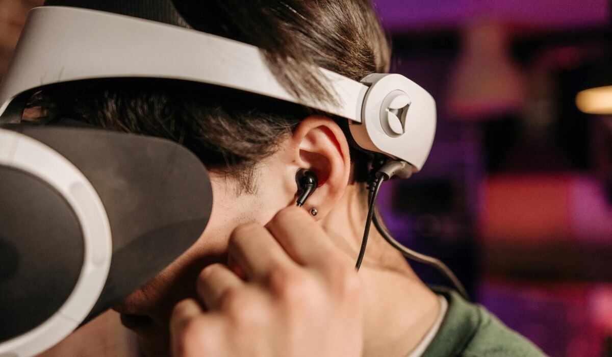 Close-up of a person wearing virtual reality headset and earphones indoors. — Photo by Pavel Danilyuk on Pexels