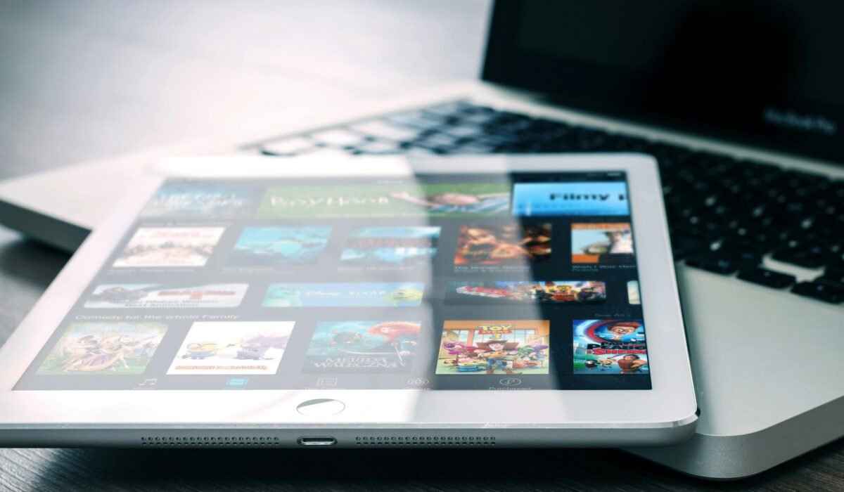 Tablet displaying streaming services on a laptop, illustrating digital entertainment setup. — Photo by Pixabay on Pexels